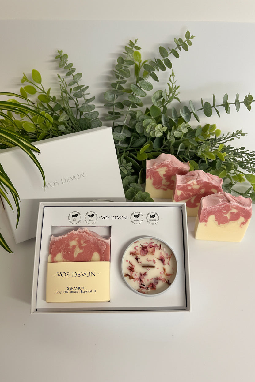 Decorative soap bars with a plant in the foreground on a light background