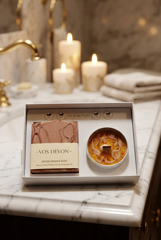 Vos Devon Spiced Orange Soap gift set in a white box, featuring a bar of orange-coloured soap and a round orange-scented candle, with the brand name visible on the packaging.